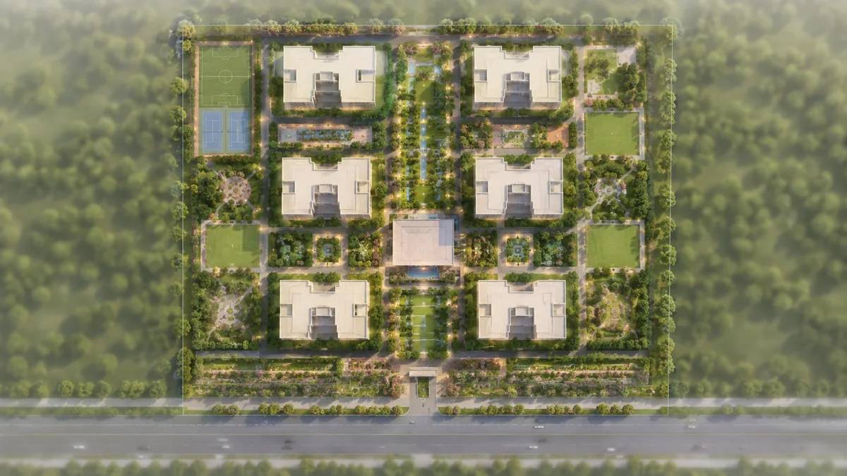 Urbanrise Begur Koppa Road master plan site layout showing the residential blocks around the central green spine, the clubhouse, the sports courts and the road frontage
